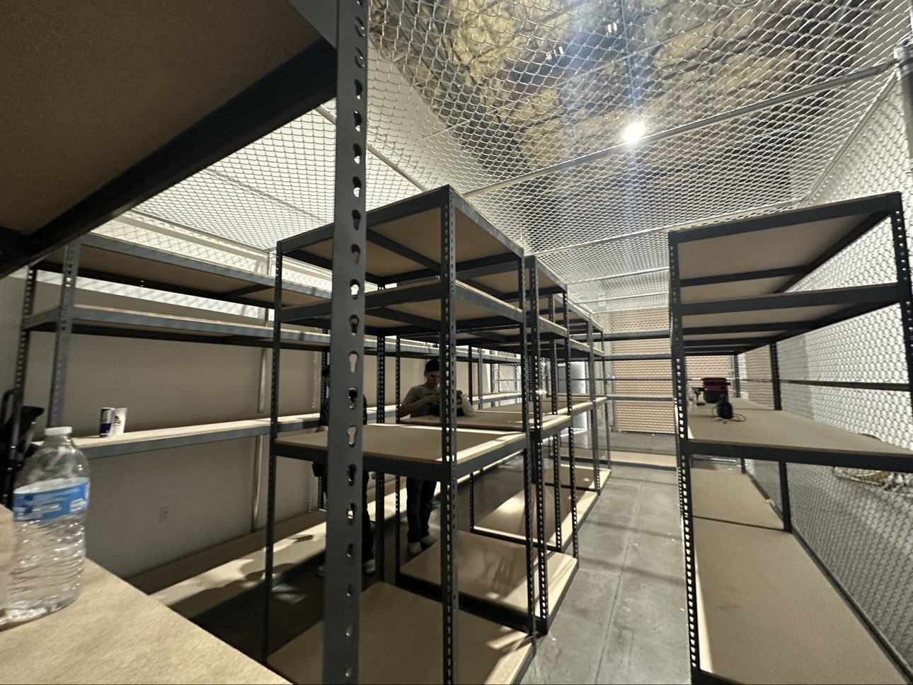 Rows of heavy-duty metal shelving assembled in a warehouse — square and level